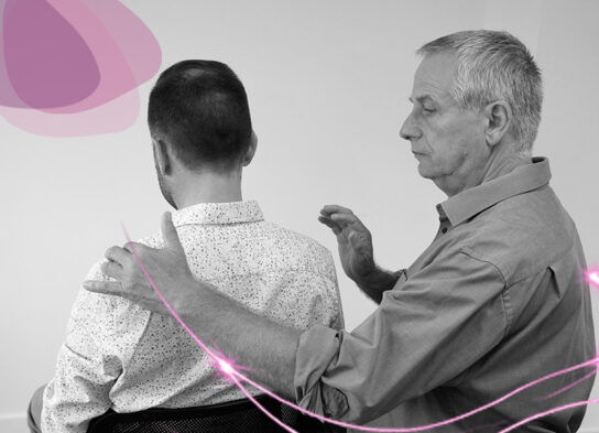Thérapeute posant une main en guidance sur l’avant-bras d’un patient, illustrant le lien intention–action dans la relation de soin